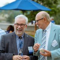Tim Bulson laughing with a guest.
